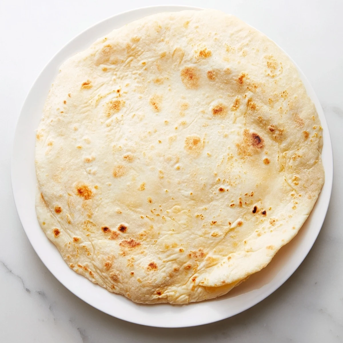 Freshly cooked Three-Ingredient Easy Flatbreads, their surface showing toasty brown spots, perfect side dish.