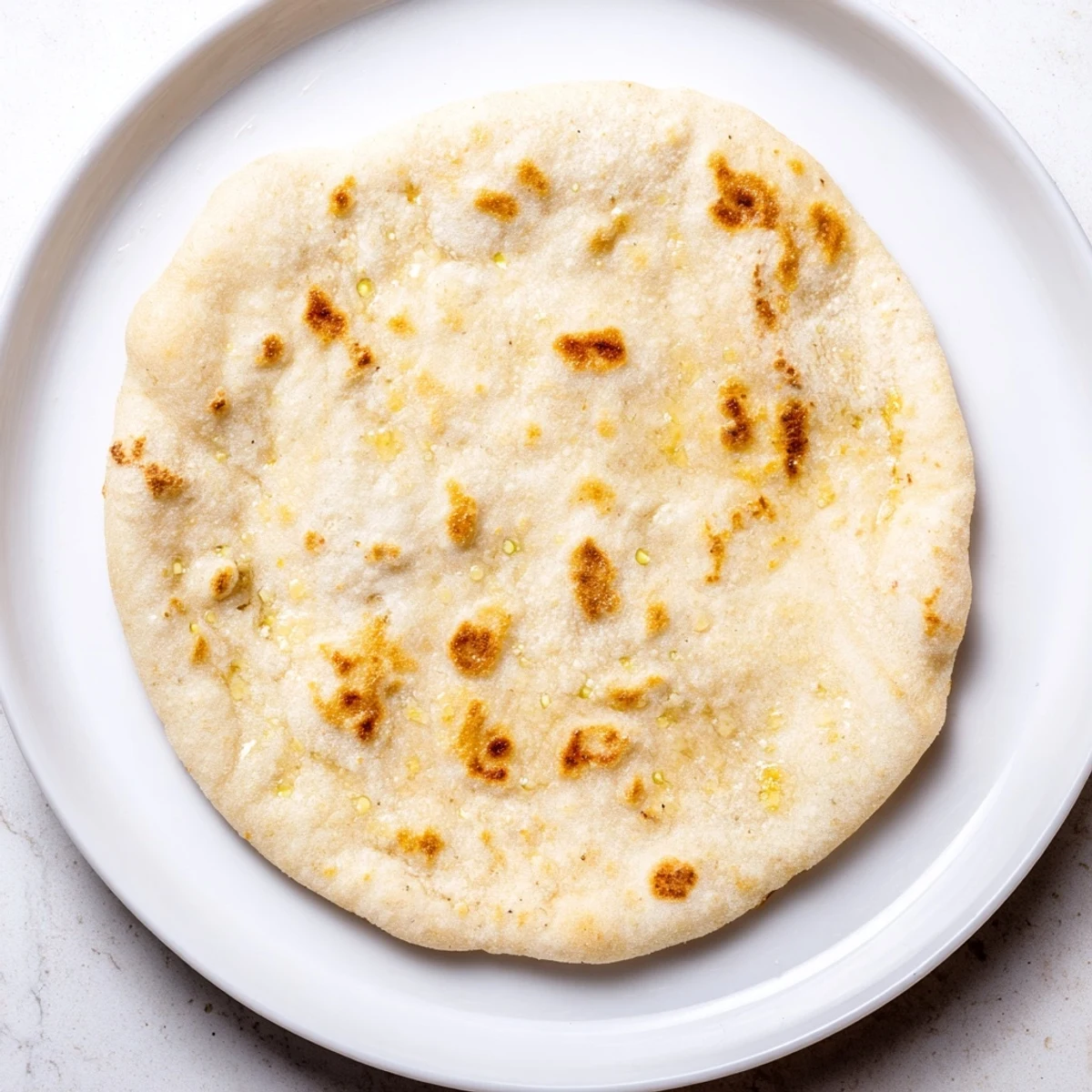 Warm, soft Three-Ingredient Easy Flatbreads, ideal for wrapping fillings or enjoying with your favorite Mediterranean dish.