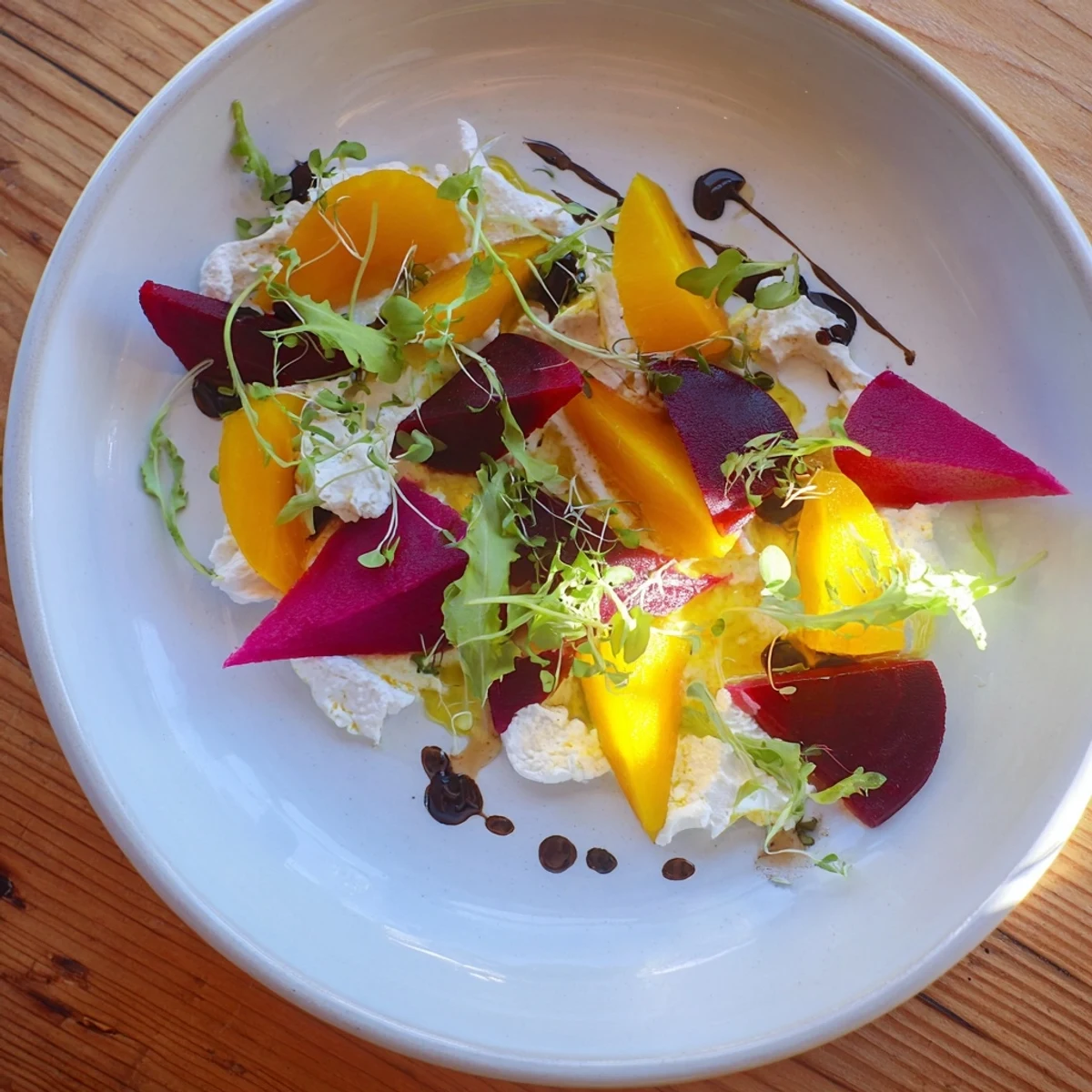 Vibrant photo: The Shadow Play appetizer features layered beets, blackberries, and microgreens for a stunning visual effect.