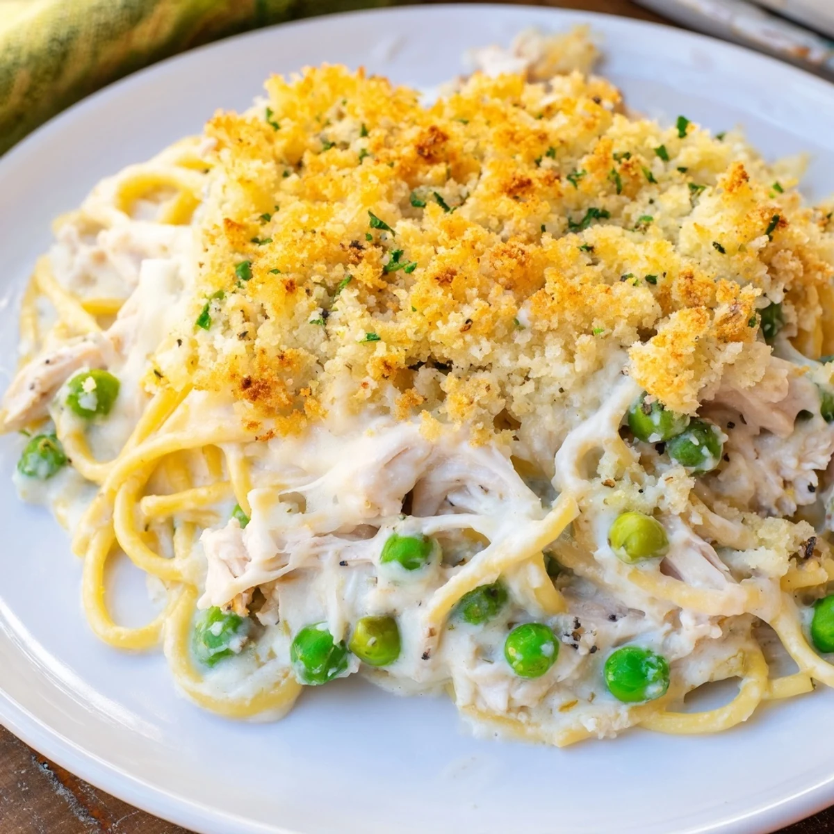 Enjoy a steaming bowl of comforting Turkey Tetrazzini with a crunchy panko topping, a perfect main course.