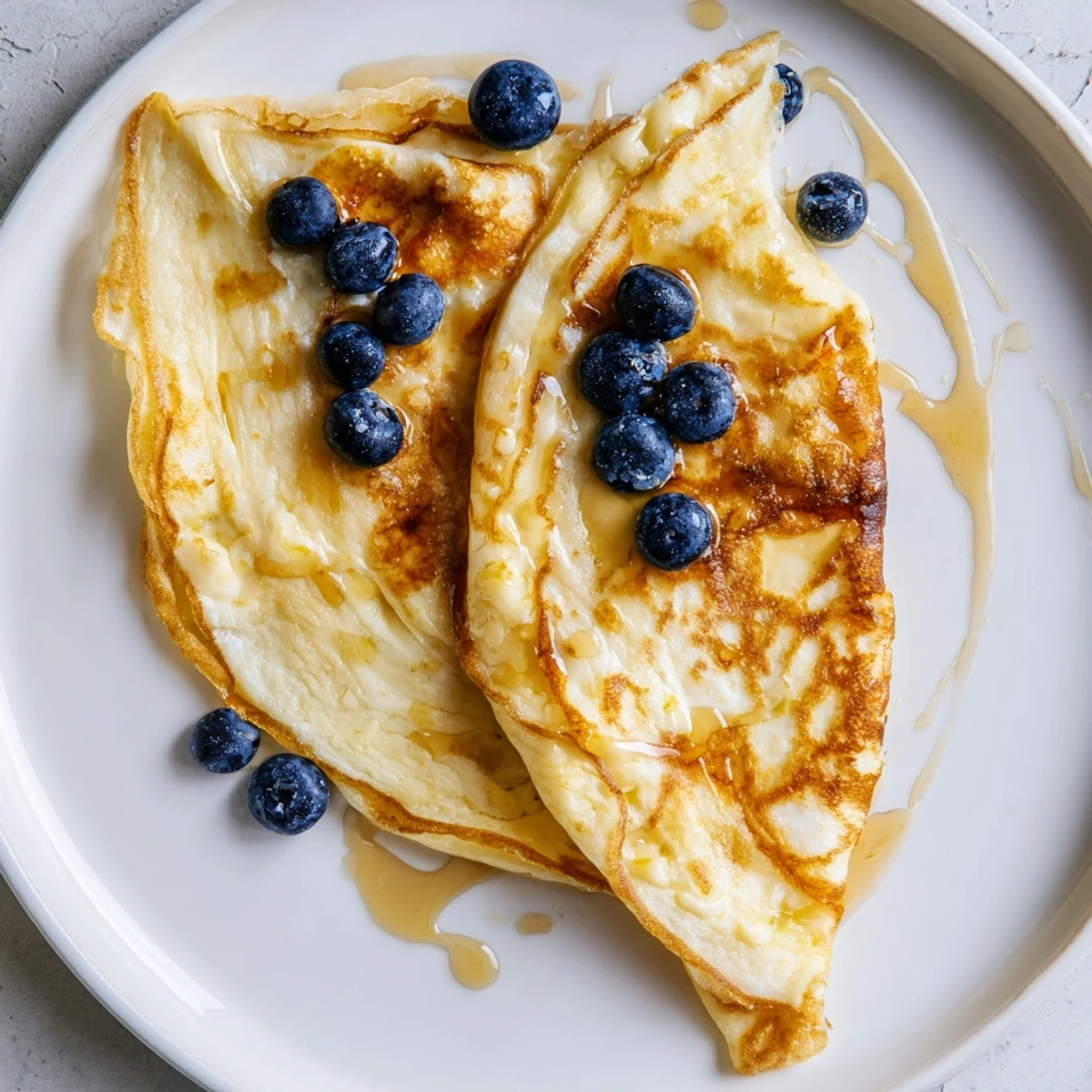 Golden brown fluffy scrambled pancakes, a delicious one-bowl breakfast with maple syrup.