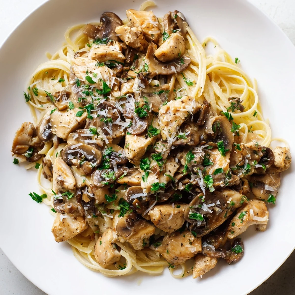Creamy mushroom chicken pasta, a comforting dish with golden chicken and creamy sauce over pasta.