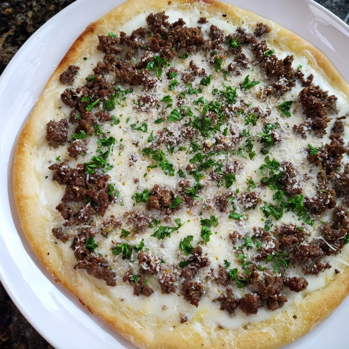 Ground Beef Alfredo Pizza, a cheesy delight with a savory ground beef and creamy Alfredo sauce.