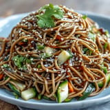 Chilled soba noodle salad glistening with colorful veggies and savory sesame ginger dressing.