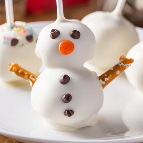 Oreo snowman cake pops, dipped in white chocolate, ready for a winter holiday treat.