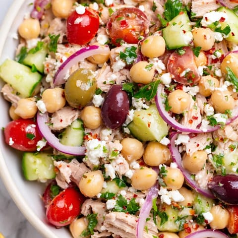 A close-up shot of refreshing Tuna Chickpea Salad, showcasing colorful ingredients and textures.