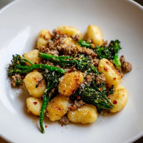 Golden roasted Sheet Pan Gnocchi Bake with crumbled Italian sausage and crisp-tender broccolini.