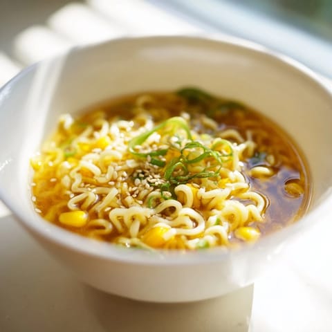 Creamy, silky Elevated Ramen Egg Drop Soup with tender noodles and delicate egg ribbons in a savory broth, served hot in a cozy bowl.  