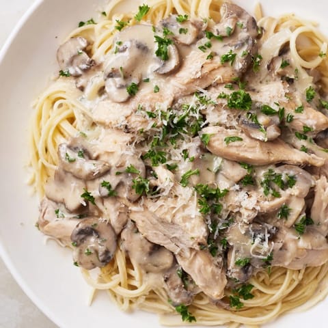 Golden sautéed cremini mushrooms and onions mingle in a creamy Parmesan sauce with whole wheat spaghettini and sliced chicken.  