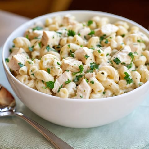 Forkful of cheesy Green Chili Chicken Mac, garnished with fresh cilantro for a vibrant Southwestern twist.  