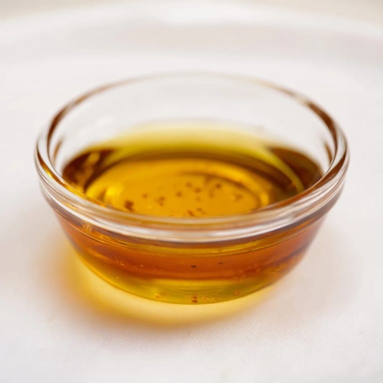 Creamy, homemade Simple Honey Vinaigrette Salad Dressing, ready to be whisked and served on greens.