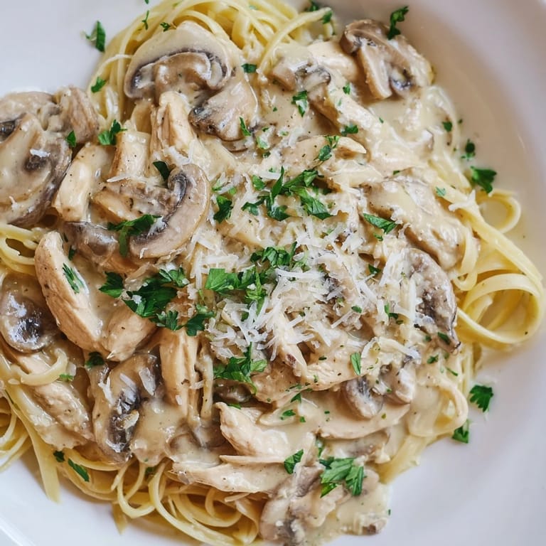 A comforting bowl of Creamy Mushroom Chicken Spaghettini served with extra Parmesan, perfect for an easy Italian-inspired dinner.