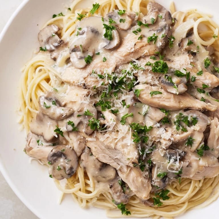 Golden sautéed cremini mushrooms and onions mingle in a creamy Parmesan sauce with whole wheat spaghettini and sliced chicken.  