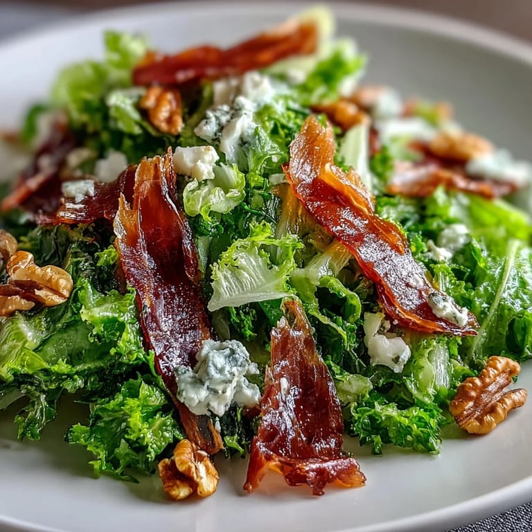 Elegant Frisée, Pear, Blue Cheese, and Crispy Prosciutto Salad, a perfect autumn starter.