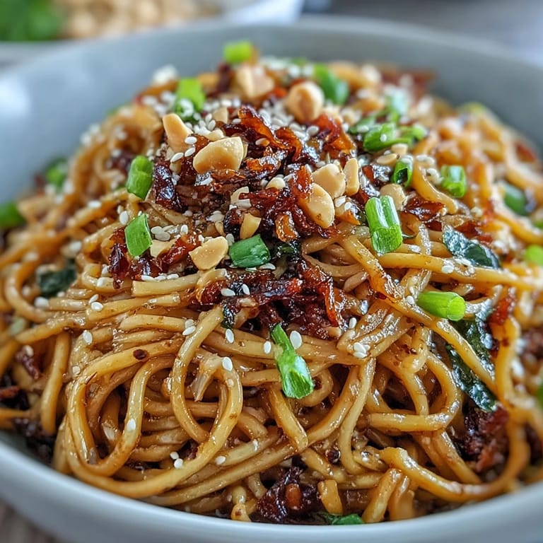 Delicious Chili Crisp Noodles glistening with garlic, perfect for a quick weeknight meal.