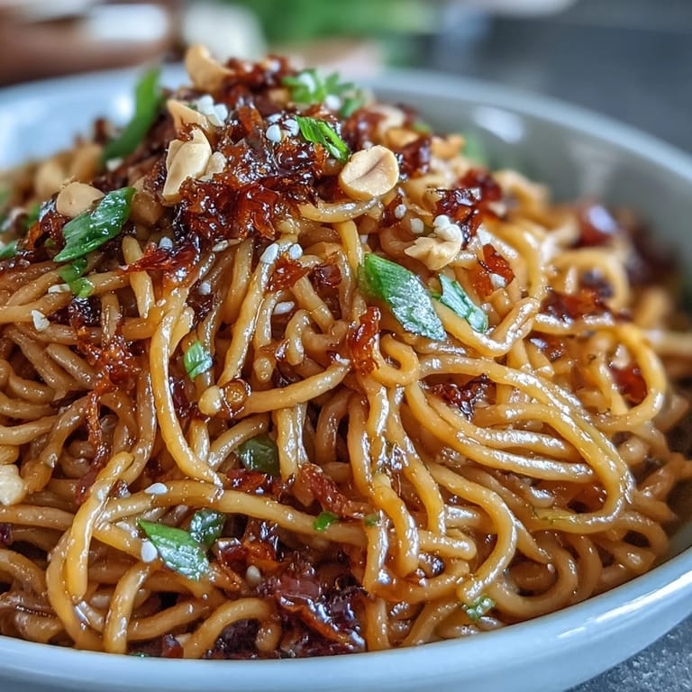 Umami-rich Chili Crisp Noodles generously topped with fresh scallions and chili crunch.