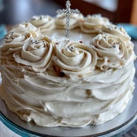 First Communion Cake with white fondant roses and cross topper on elegant display