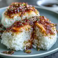Golden brown grilled salmon onigiri, crisped to perfection, ready for dipping.